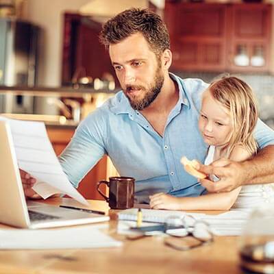 Dad and daughter looking at retirement paperwork